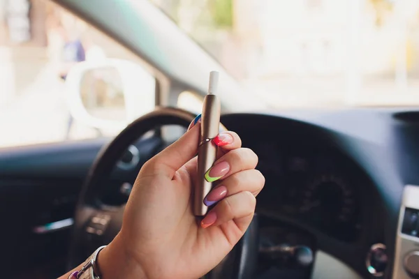 heat-not-burn tobacco product technology. e-cigarette before smoking in the car.