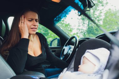 Kadın oğlunu arabada çocuk koltuğu üzerinde tespit etmek.