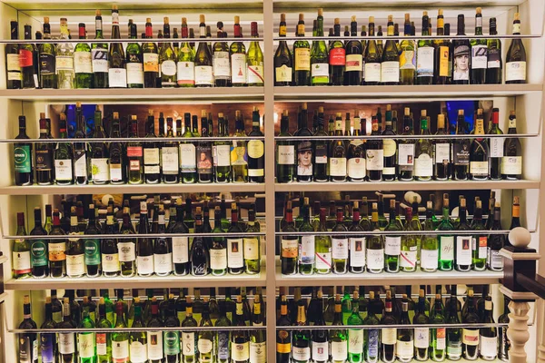 Ufa, Russia, 5 November, 2018: Closeup shot of wine shelf. Bottles lay over straw. Wine cellar. — Stock Photo, Image