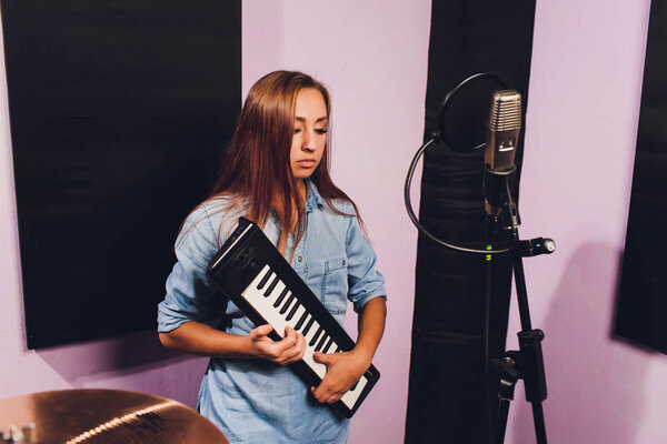 Close up of a singer recording a track in a studio.