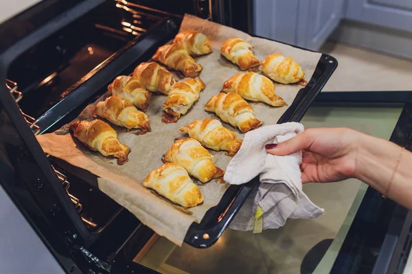 Freshly baked croissants in the baking oven. — Stock Photo, Image