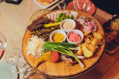 İtalyan antipasti şarap aperatifleri. Fırçalar, peynir çeşitleri, Akdeniz zeytinleri, turşular, kavunlu Prosciutto di Parma, salam ve şarap siyah grunge arka planda, üst manzara.