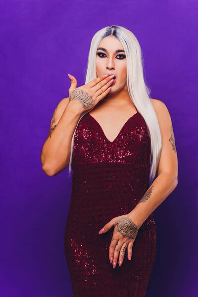 Portrait of young transgender woman on color background.