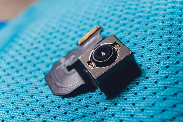 Close-up of camera sensor chip on cloth background.