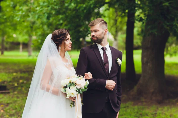 Noiva feliz e noivo em um parque em seu dia do casamento . — Fotografia de Stock
