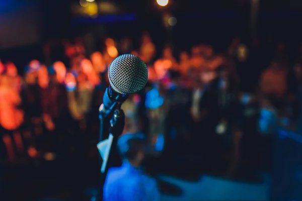 Close up of microphone in concert hall or conference room.