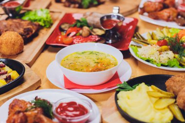 Akşam yemeği parti gıda kavramı. Izgara sosis ile yemek masası, tortilla saran, bira içmek ve ahşap masa, rustik tarzı üzerinde farklı yemekler.