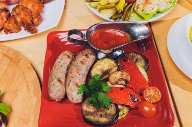 Çeşitli abur cubur ve salatalarla dolu yemek masası. Somon, zeytin, şarap, sebze, ızgara balık tostu. Aile yemeği konsepti. Şükran Günü, Noel. Üst veiw.