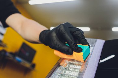 Araba temizleme - Adam arabaya nano koruyucu kaplama uyguluyor. Seçici odak.