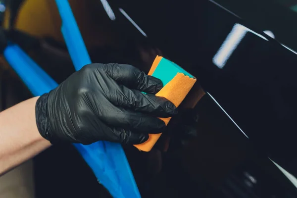 Car detailing - Man applies nano protective coating to the car. Selective focus. — Stock Photo, Image