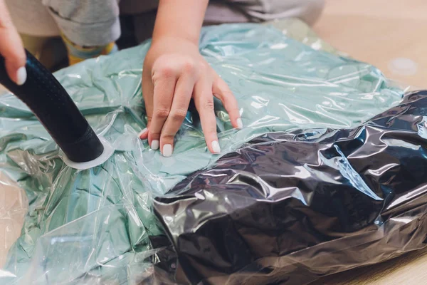 Space saver saving seal bag sucking air out , vacuum clothing storage compressed package. — Stock Photo, Image