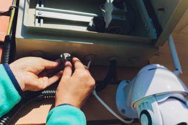 Duvarda teknisyen kadın güvenlik kamerası var..