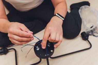 Yerdeki kablolar ve aletlerle avize, kuruluma hazırlık.