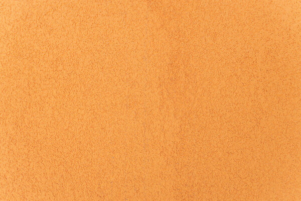 The yellow plastered wall with fine texture.