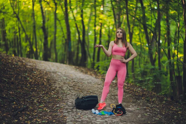 Jovem mulher sorridente caminhante caminhando trilha de montanha, andando em colina gramada, usando mochila. Atividade ao ar livre, conceito de turismo . — Fotografia de Stock