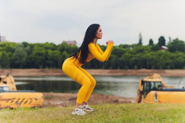 Yaz günü tayt ve yeleklerle spor yapan çekici bir kız..