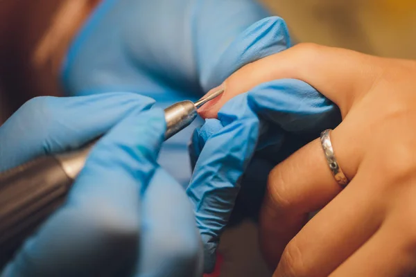 Cuidado de uñas en un salón de belleza. Manicura quitando bordes con tijeras. Deja que tus manos se vean hermosas. —  Fotos de Stock