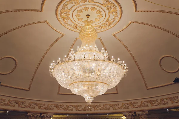 Chrystal chandelier lamp on the ceiling in Dining room Adjusting the image in a Luxury tone .Decorative elegant vintage and Contemporary interior Concept.