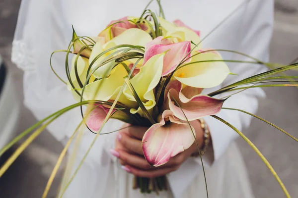Bruiloft boeket van witte lelies modieuze close-up in handen. — Stockfoto