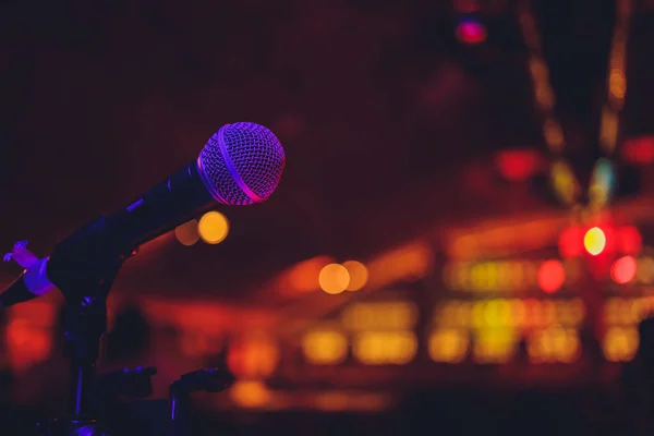 Close up of microphone in concert hall or conference room.