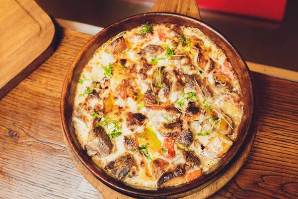 Fried mushrooms in a creamy sauce cooked in a frying pan. — Stock Image Fried mushrooms in a creamy sauce cooked in a frying pan. Stock Image