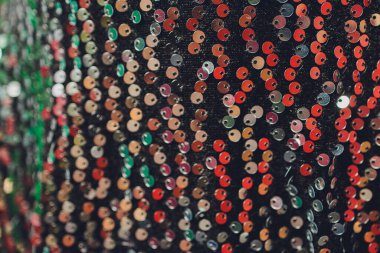 Makroyu yakınlaştırır. Kumaşın üzerinde pullu soyut arkaplan.