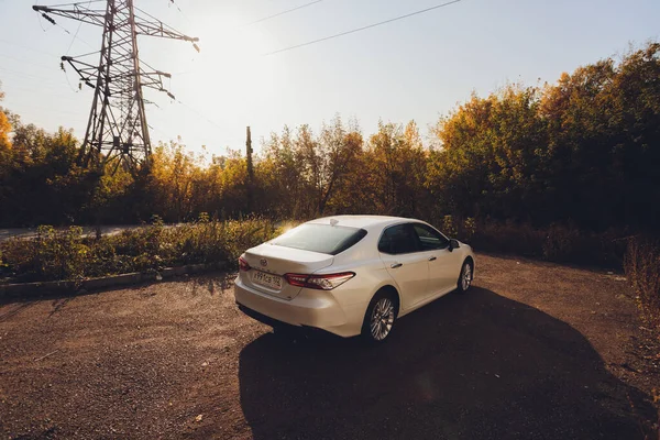 Ufa, Rusia, 07-10-2020: Nuevo modelo híbrido Toyota Camry 2020. Vista frontal general durante la puesta del sol. — Foto de Stock