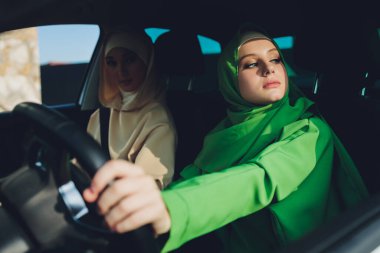 Arabayla seyahat eden Arap genç kadın çift.