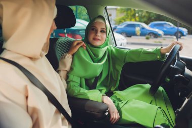 Arabayla seyahat eden Arap genç kadın çift.