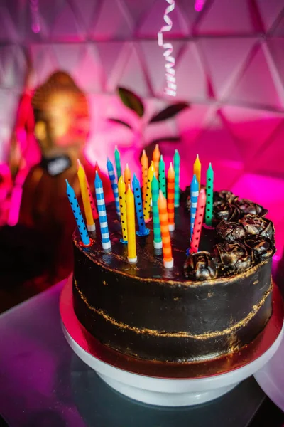 Birthday cake with candles, bright lights bokeh. — Stock Photo, Image