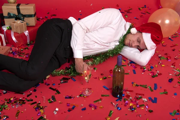 Young businessman hangover sleeping after drinking of alcohol in office. christmas and happy new year party.