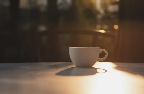 Espresso coffee cup on table cafe and sunlight in the morning. — Stock Photo, Image