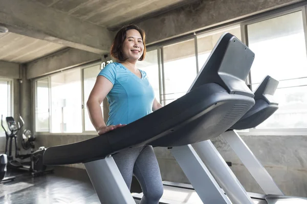 Senior woman runner at gym fitness smiling and happy. — Stock Photo, Image