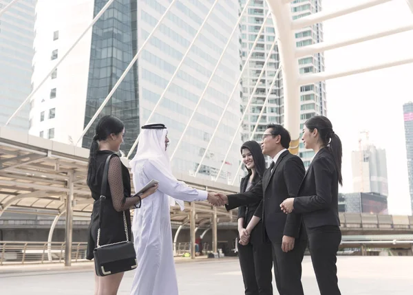businessman arabic with business people making handshake