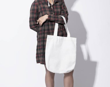 Kız çantası kanvas kumaş mockup boş şablon için tutuyor 