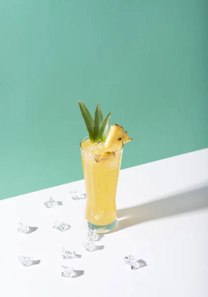 Iced pineapple punch cocktail in glass on color background. — Stock Photo, Image