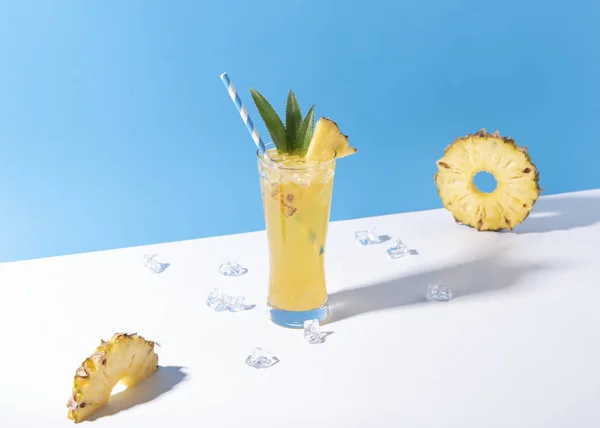 Iced pineapple punch cocktail in glass on color background. — Stock Photo, Image