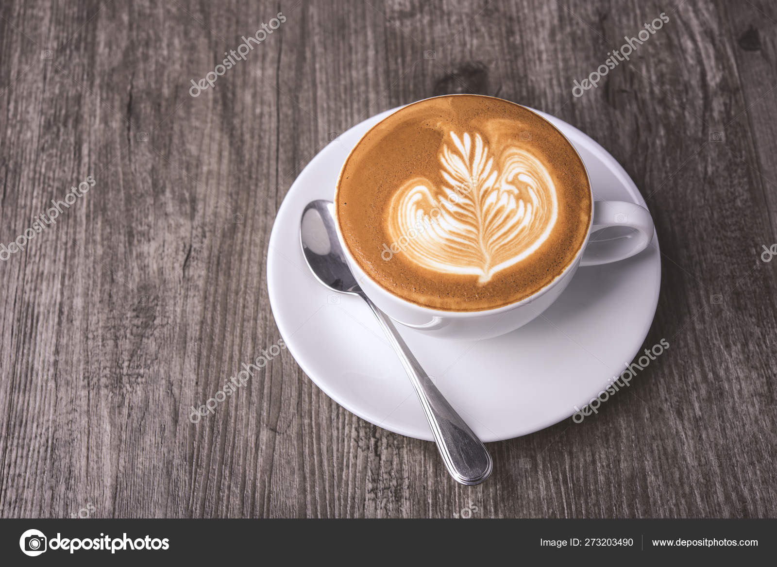 latte or Cappuccino with frothy foam, coffee cup top view on table in cafe.  Stock Photo