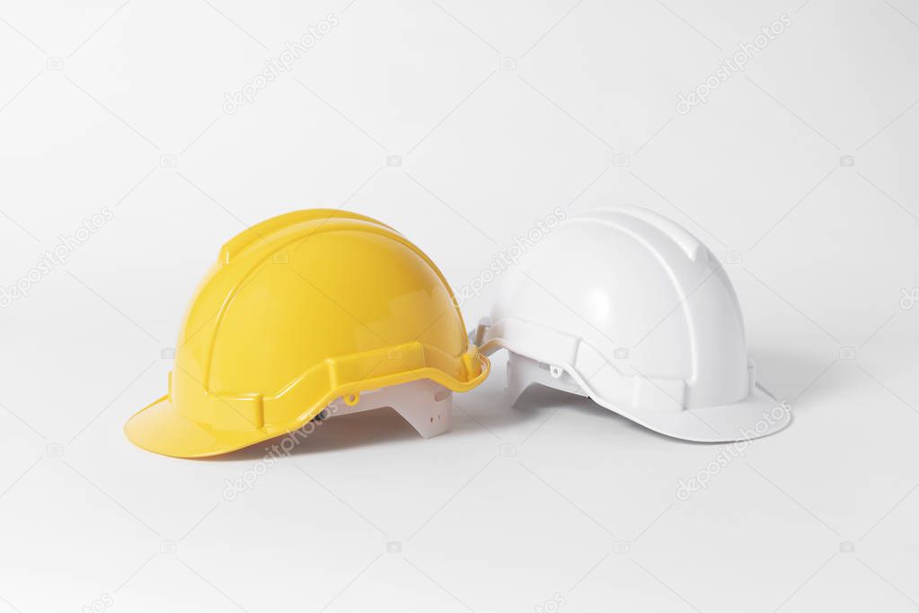 Plastic safety helmet for engineer on gray background.