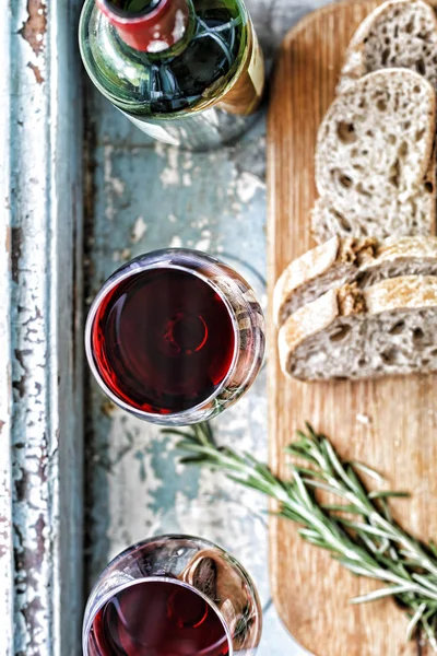 Wine and bread. View from above. Seletive focus. Vintage background.