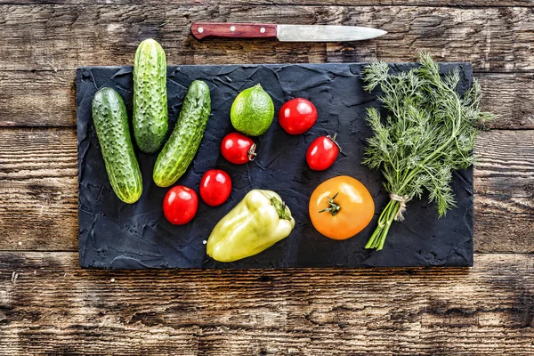 Detox-salad. Ingredients for vegetable salad on a stone black board. Healthy food