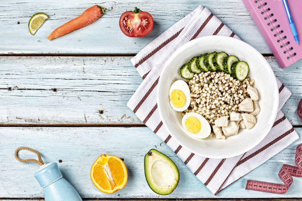 Mix barley and wheat porridge with boiled eggs, tomatoes, cucumbers. Barley couscous, pearl barley, bulgur wheat, green lentils. Healthy food concept. copy space. top view