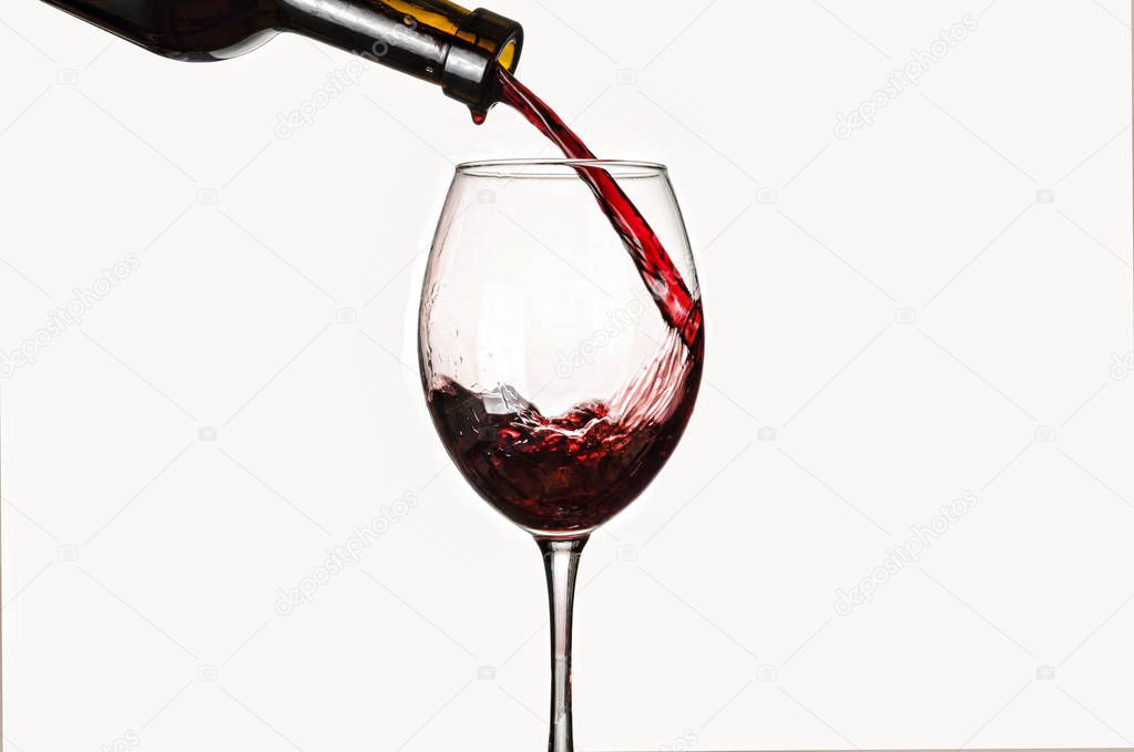 Pouring wine. Isolated on white background.