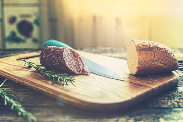 Salami and baguette for breakfast. Summer morning on the kitchen table