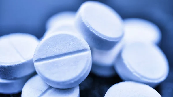 Macro white pills. Innovative technologies. Modern medicine. Macro on black background
