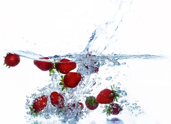 Wasserspritzer Mit Einer Fliegenden Erdbeere Auf Weißem Hintergrund — Stockfoto