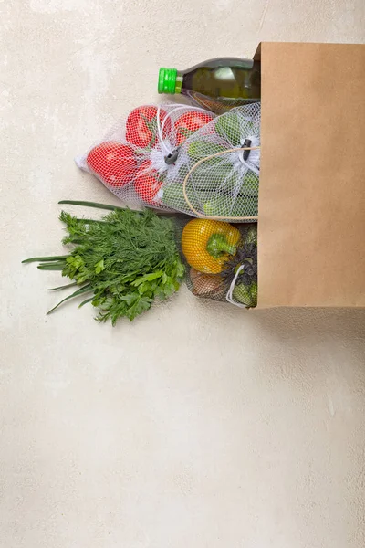 Paper bag vegetables delivery from supermarket. Fresh vegetables and herbs, order delivery via the Internet