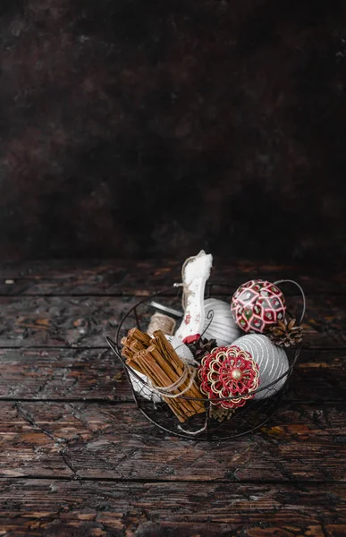 Pile Christmas Decorations Cinnamon Barks Metal Basket Dark Wooden Background — Stock Photo, Image