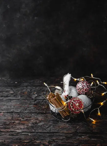 Pile Christmas Decorations Cinnamon Barks Metal Basket Dark Wooden Background — Stock Photo, Image