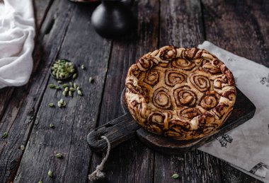 Tarçın baharat pastayla rustik ahşap arka plan üzerinde yuvarlandı. 